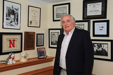 Dick Ollen, surrounded by Northeastern memorabilia, in his home in New Hampshire.